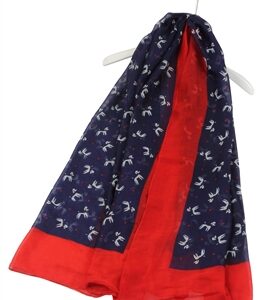 Navy scarf with white poodle silhouettes and a red trim