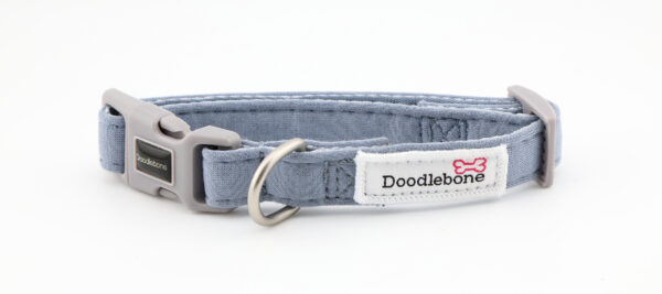Chalky Blue dog collar with embroidered dog-themed patches and brushed nickel hardware