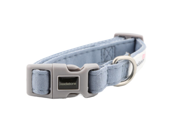 Chalky Blue dog collar with embroidered dog-themed patches and brushed nickel hardware