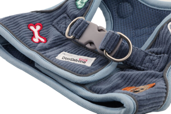 Back view of blue cord dog harness with brushed nickel D-rings and step-in design