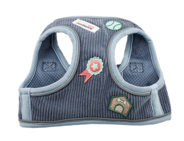 Front view of blue cord dog harness with embroidered dog-themed patches and brushed nickel hardware