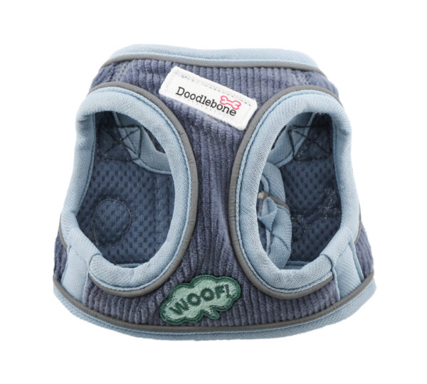 Front view of blue cord dog harness with embroidered dog-themed patches and brushed nickel hardware